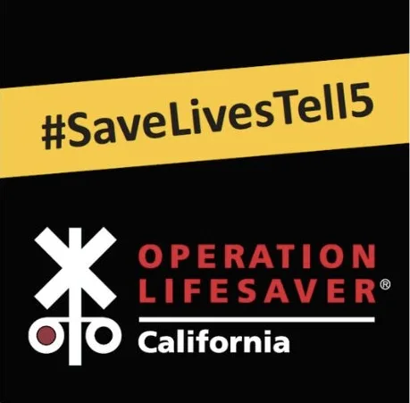 Black background with a yellow band reading #SaveLivesTell15. Below, a white railroad crossing symbol and text: Operation Lifesaver California. The overall design promotes rail safety awareness in California.